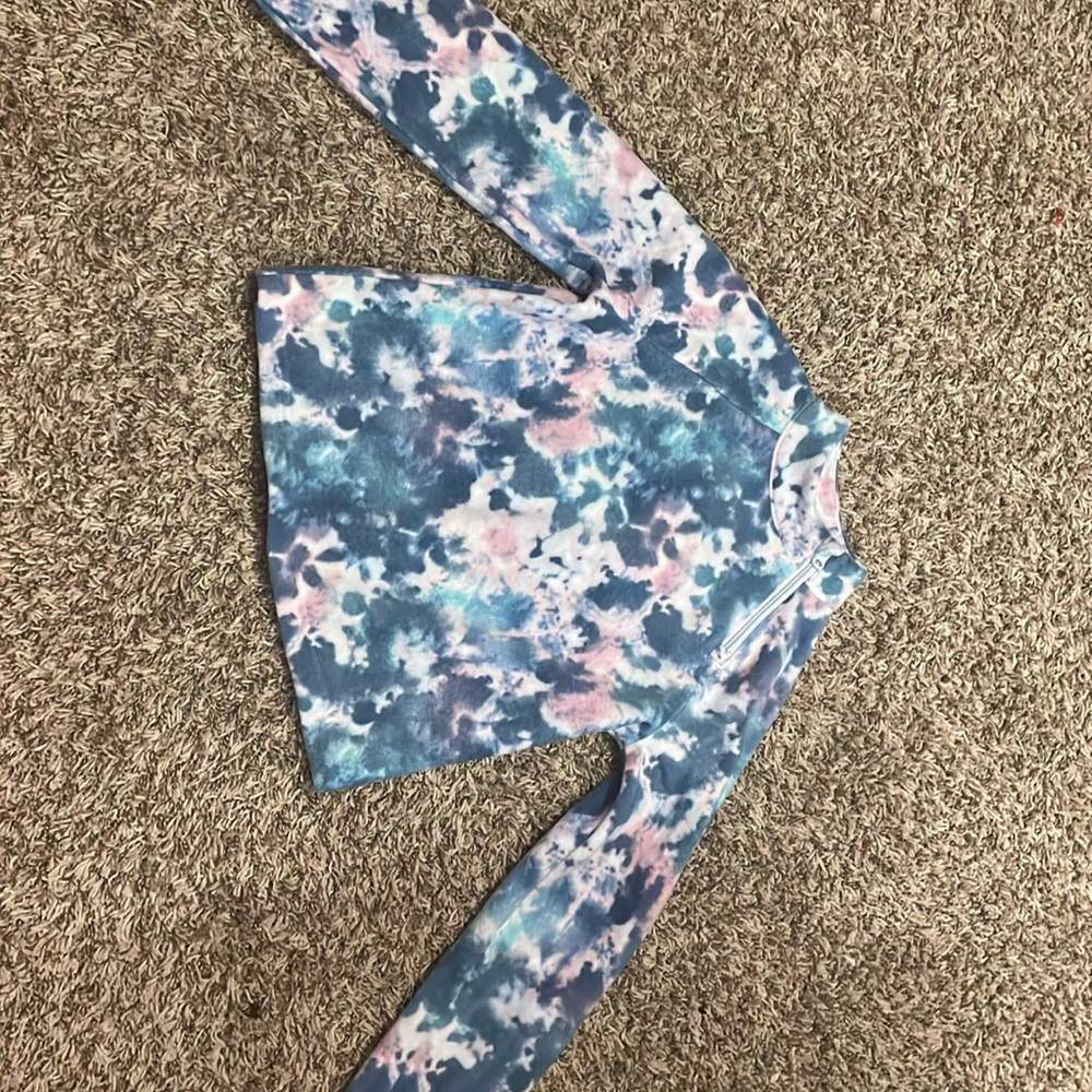 We’re selling a tie-dye sweater that wraps around the neck.